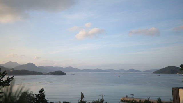 Peaceful coastal scenery under a blue sky with clouds