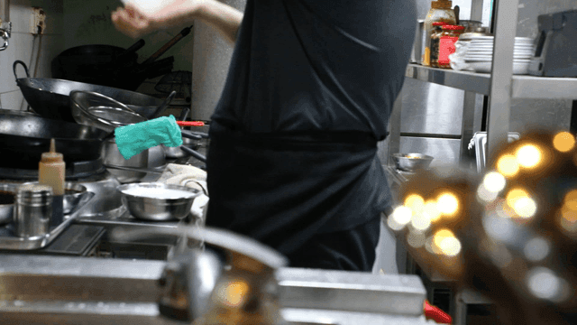 Chef preparing food in a busy kitchen