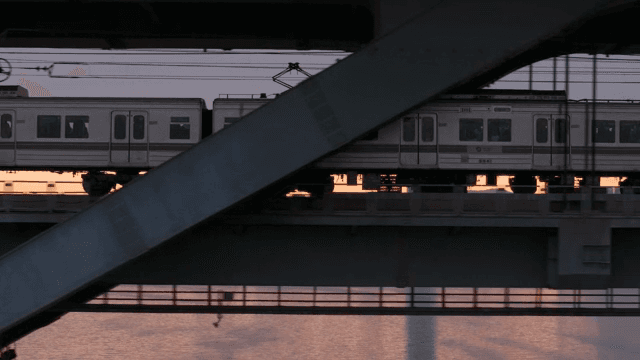 Train crossing a bridge at sunset