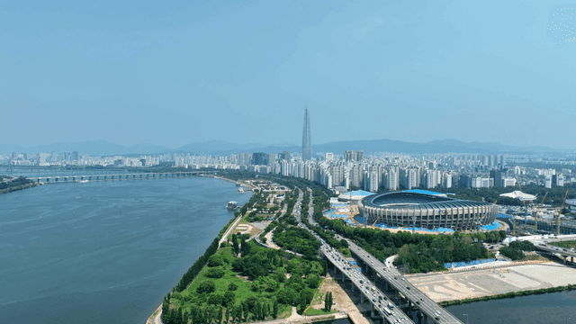 Vast city landscape with river and stadium