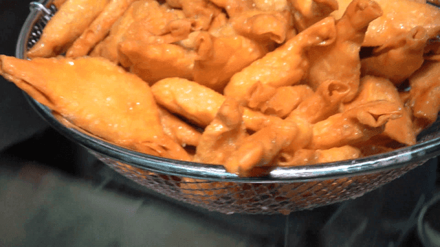 Fried dumplings lifted from hot oil