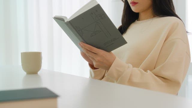 Woman Reading a Book in a Bright Room