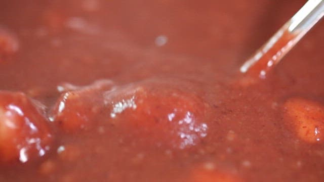 Spoonful of red bean porridge with rice cake balls