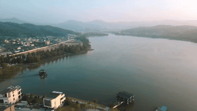 Tranquil lake surrounded by hills and villages
