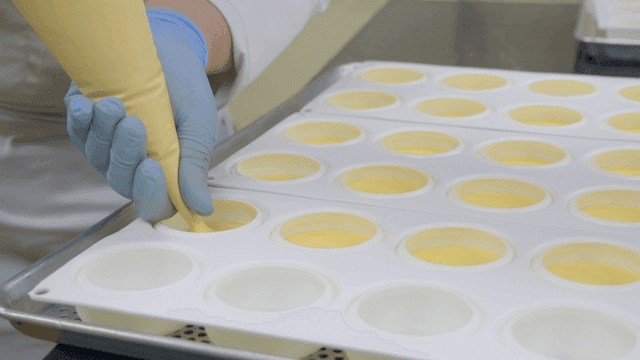 Baker filling mold with yellow dough