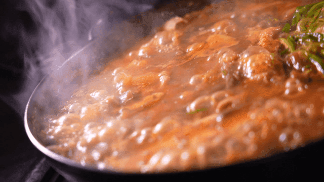 Steaming pot of boiling tripe stew