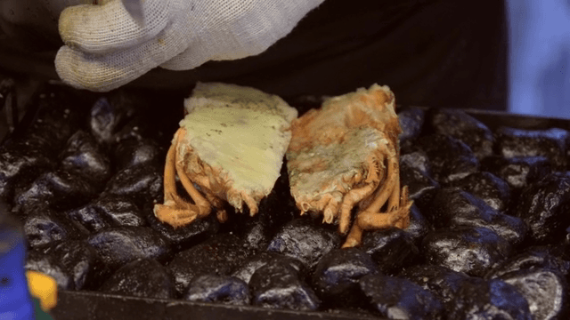 Grilled lobster with cheese on hot stones