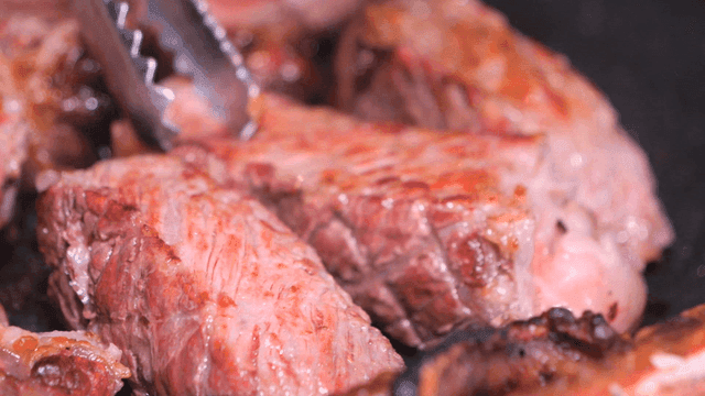 Juicy steak sizzling on a hot grill