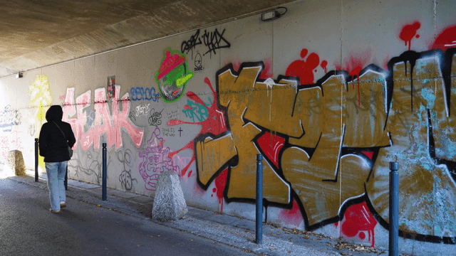 Graffiti-covered wall in tunnel