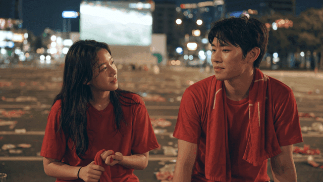Couple talking in red t-shirts after cheering at night