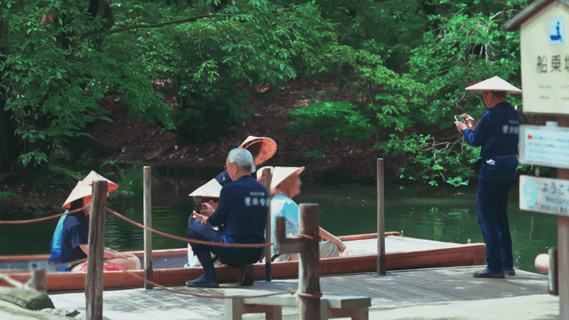 People on a boat in a lush green park