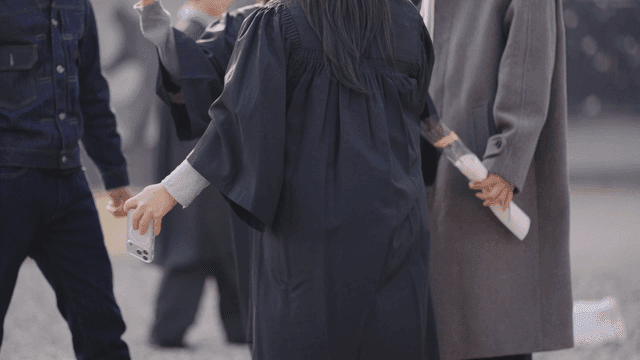 Graduates taking selfies with their friends