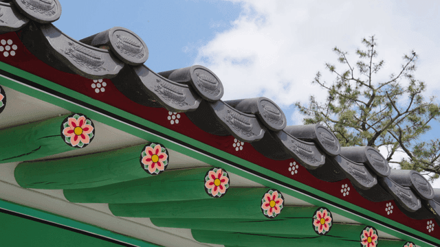 Traditional Korean roof eaves with floral patterns