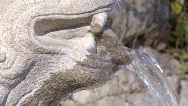 Water flowing from a stone sculpture