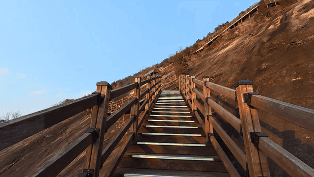 Wooden stairs leading up a mountain slope