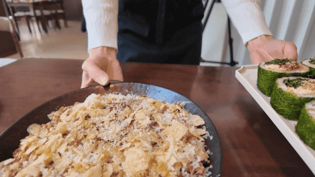 A server bringing dishes to a table