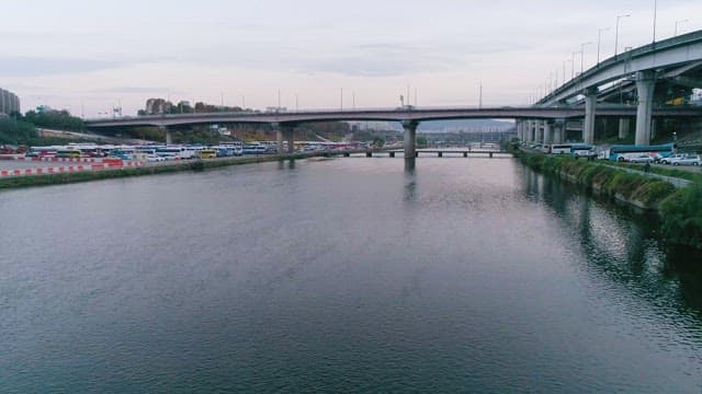 강과 가장자리에 주차된 버스가 있는 다리