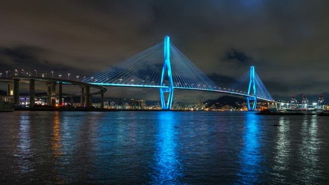 Colorful illuminated Busanhangdaegyo Bridge at night with cityscape
