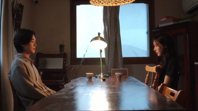 Couple in a heavy mood sitting at a table