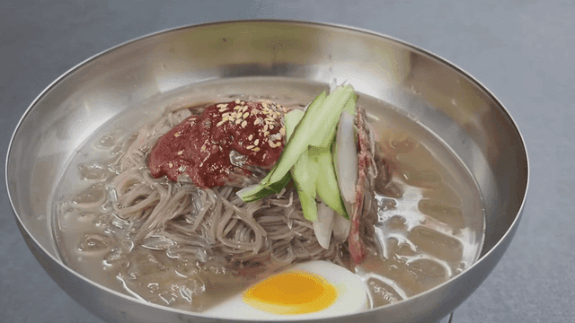Bowl of cold noodles with toppings.