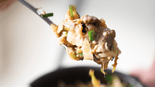 Spoonful filled with stone pot rice