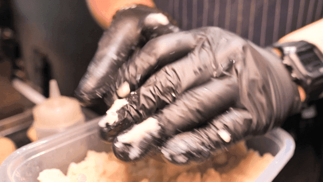 Hands shaping dough in a kitchen
