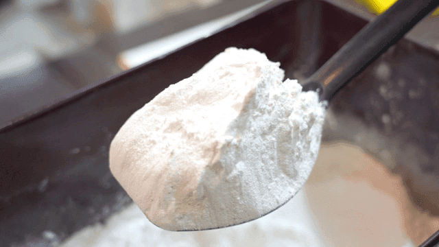 Sight of scooping flour with black spoon