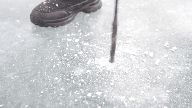 Drilling a hole in the ice for fishing