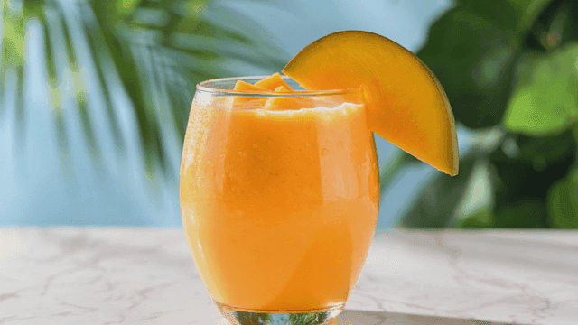 Refreshing mango smoothie in glass.