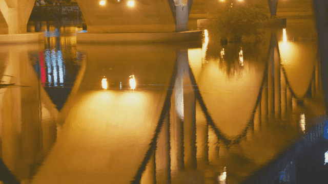 Bridge reflection on calm river at night