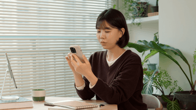 Young woman using smartphone at home