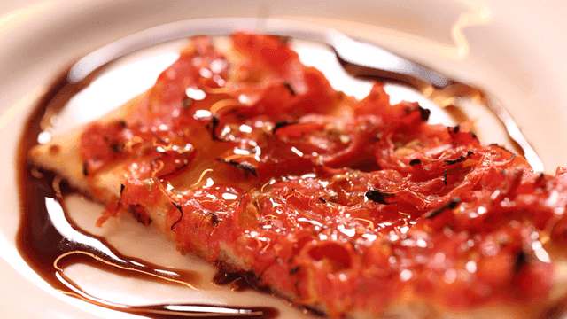 A slice of pizza with toppings and sauce