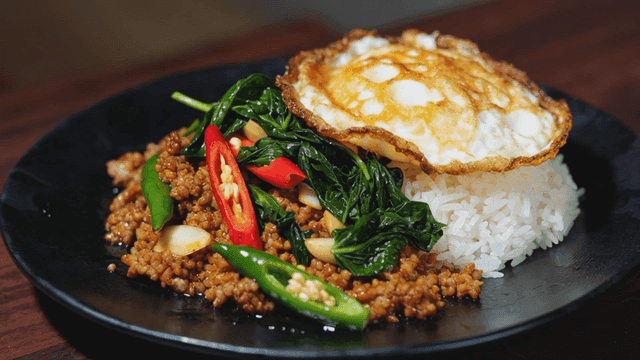 Delicious Pad Krapao Moo Sap with rice and fried egg