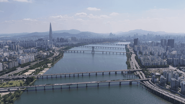 Vast city landscape with river and bridge