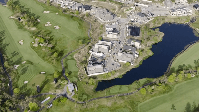 Modern golf course with clubhouse and greenery