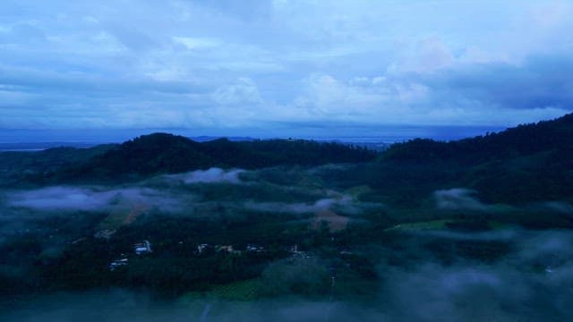 Misty mountains under a cloudy sky