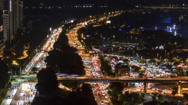 Busy city highway at nighttime with heavy traffic