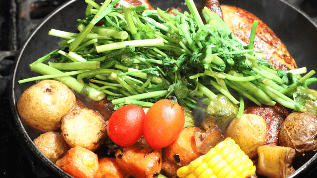 A variety of vegetables and meat in a pan