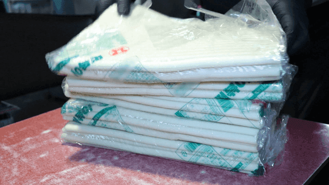 A person preparing packaged rice cakes