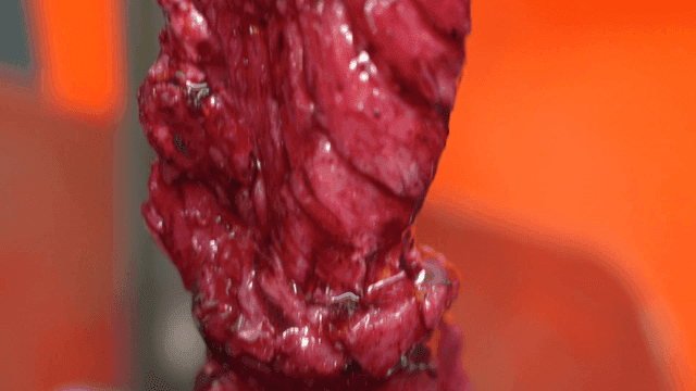 Raw meat marinated in purple sauce
