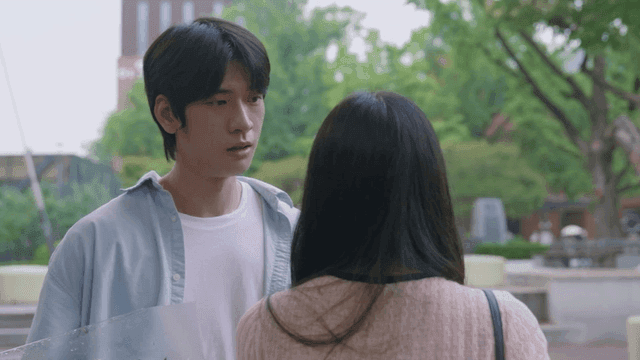 Man holding flowers and a woman leaving