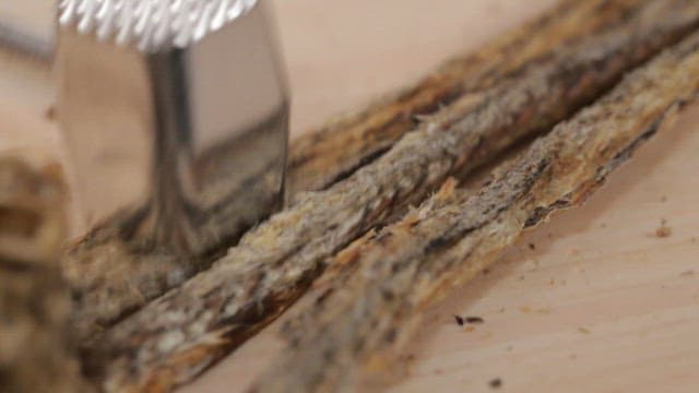 Preparing dried fish on a wooden board