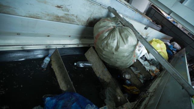 Conveyor belt transporting various waste materials indoors