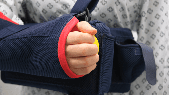 Patient with one arm holding stress ball