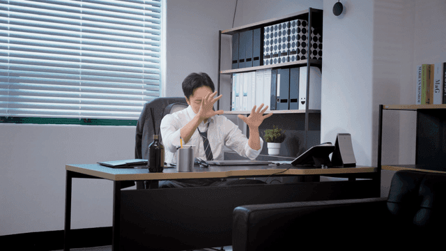 Man in office deep in thought