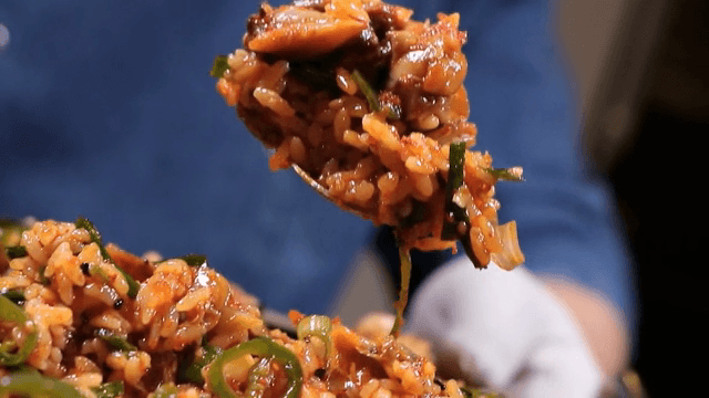 Spoonful of well-mixed cockle bibimbap