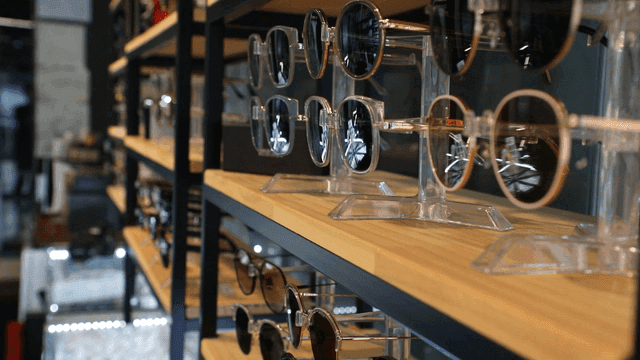Sunglasses displayed on wooden shelves