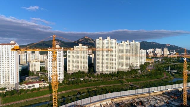 Urban Expansion with Construction Cranes