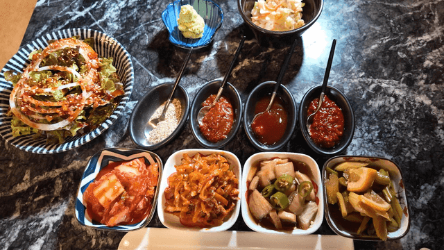 Variety of restaurant side dishes on table