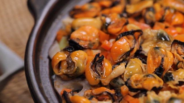 Mussels cooked in a pot with vegetables